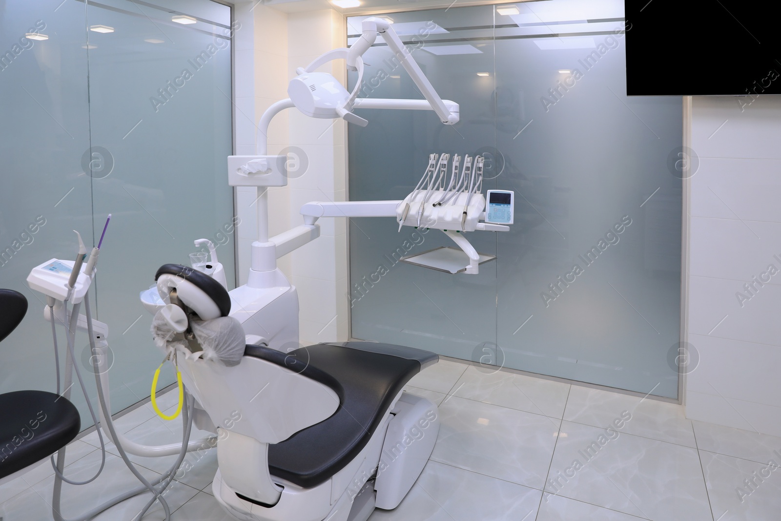 Photo of Dentist's office interior with chair and modern equipment