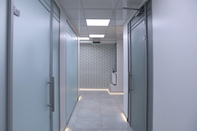 Photo of View of empty hospital corridor with doors