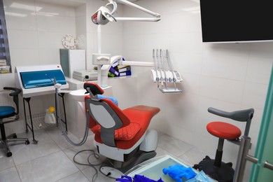 Photo of Dentist's office interior with chair and modern equipment