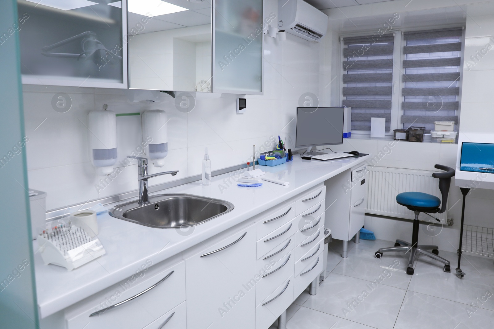 Photo of Dentist's office interior with furniture and modern equipment