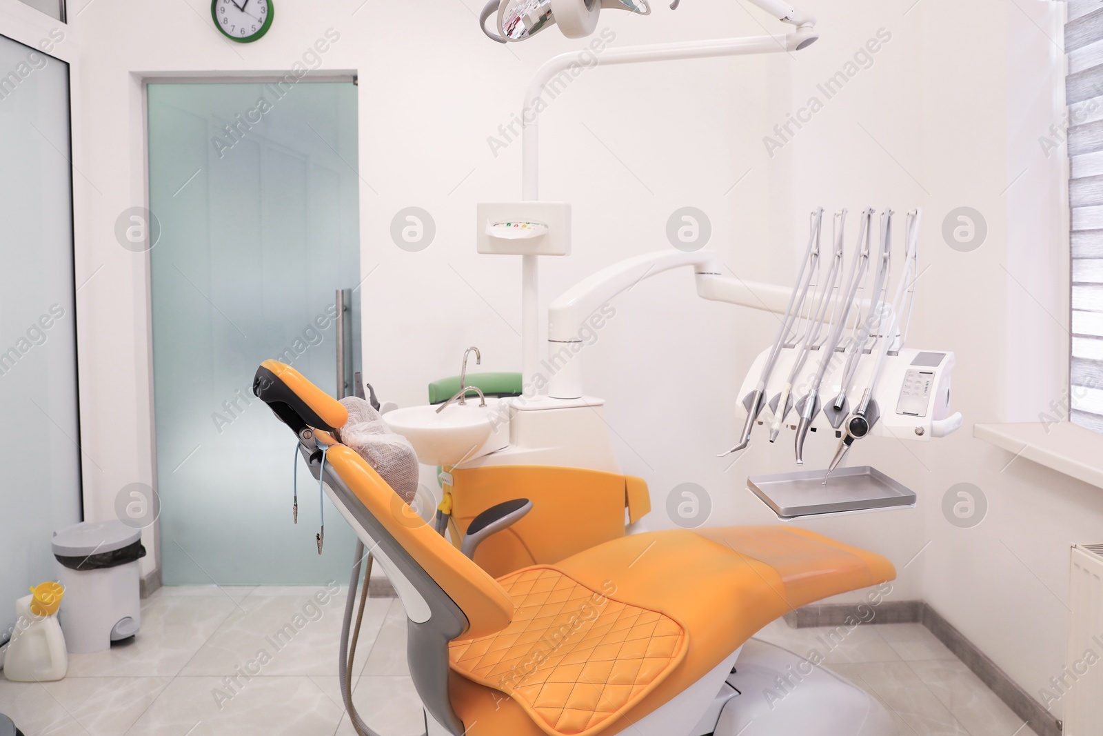 Photo of Dentist's office interior with chair and modern equipment