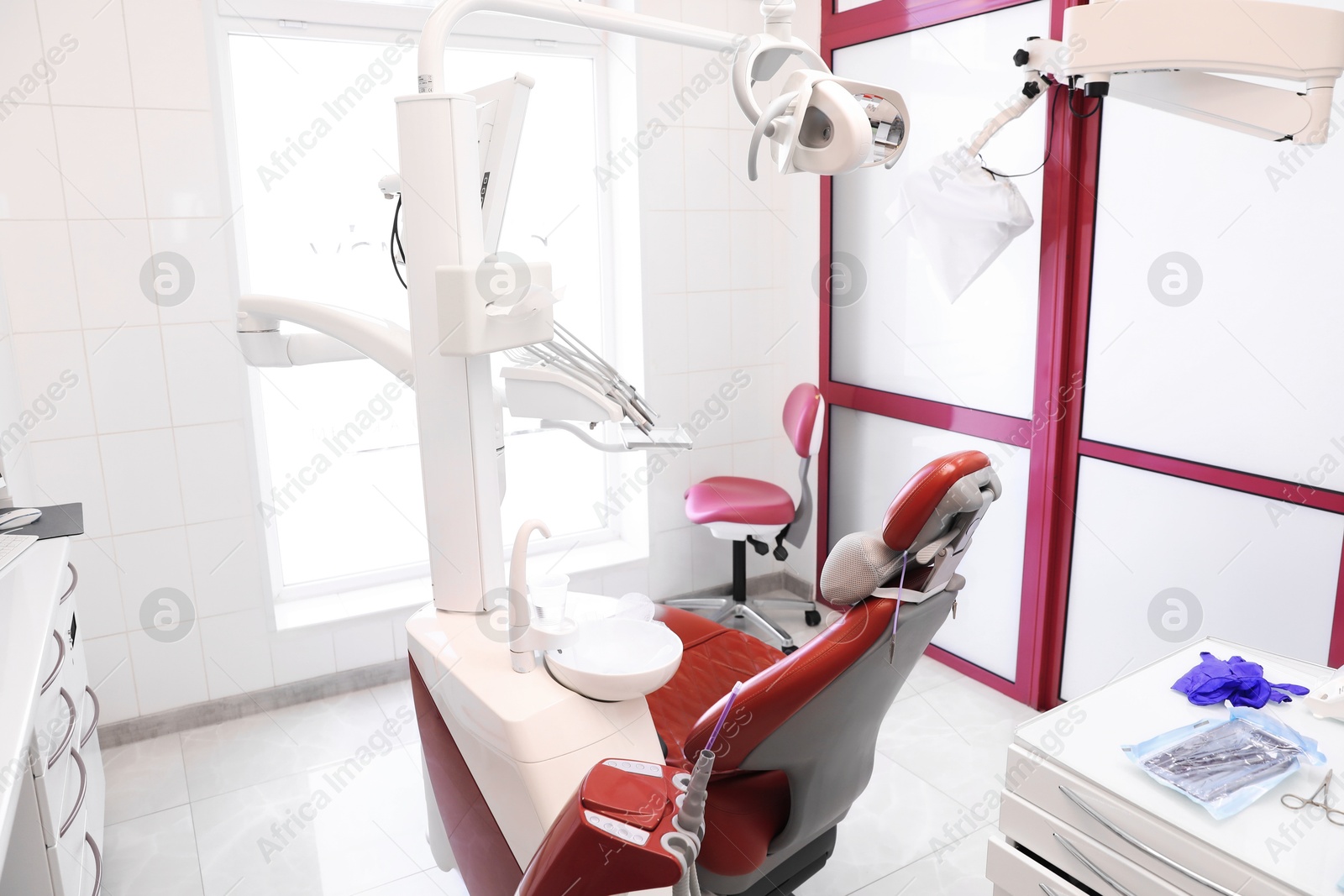 Photo of Dentist's office interior with chair and modern equipment