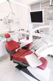 Photo of Dentist's office interior with chair and modern equipment