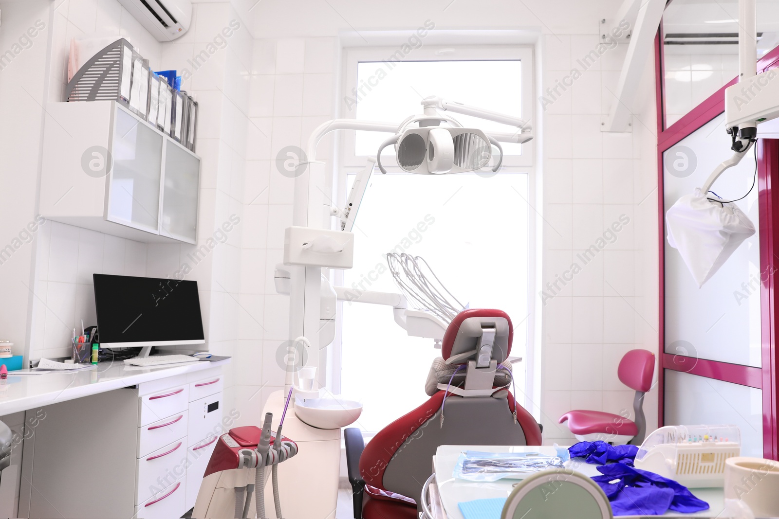 Photo of Dentist's office interior with chair and modern equipment