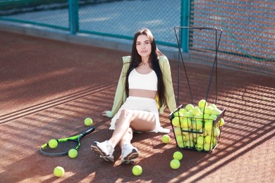 Beautiful woman in sportswear on tennis court