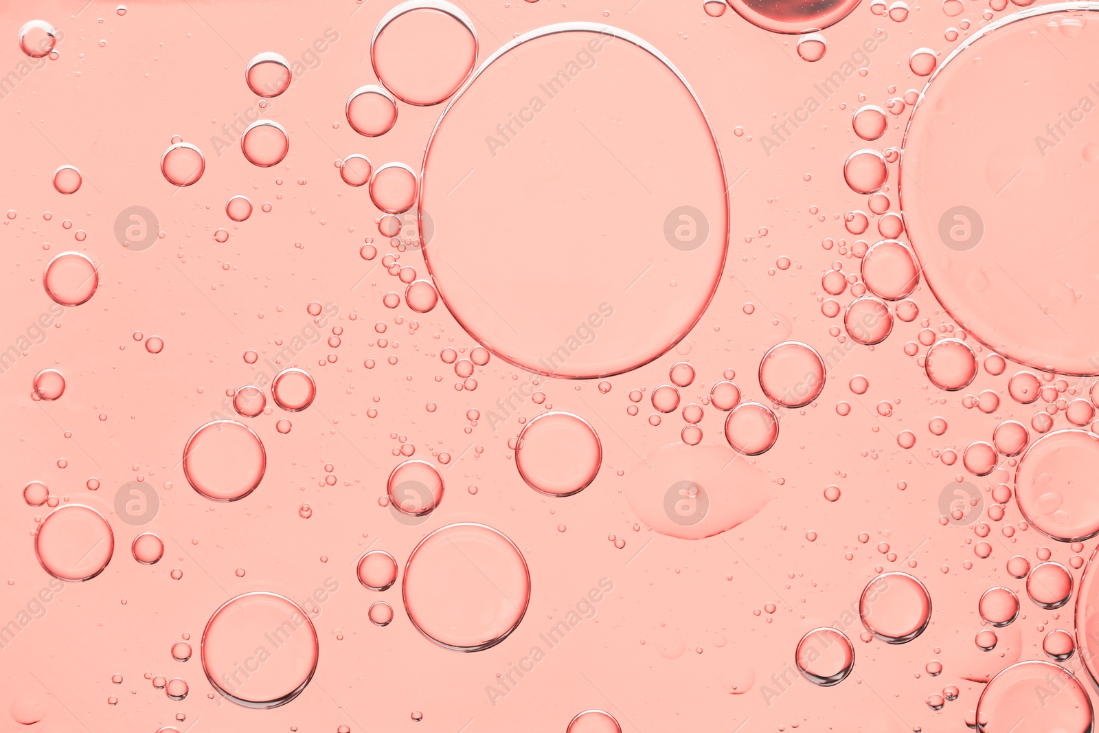 Image of Cosmetic oil on peach fuzz color background, macro view