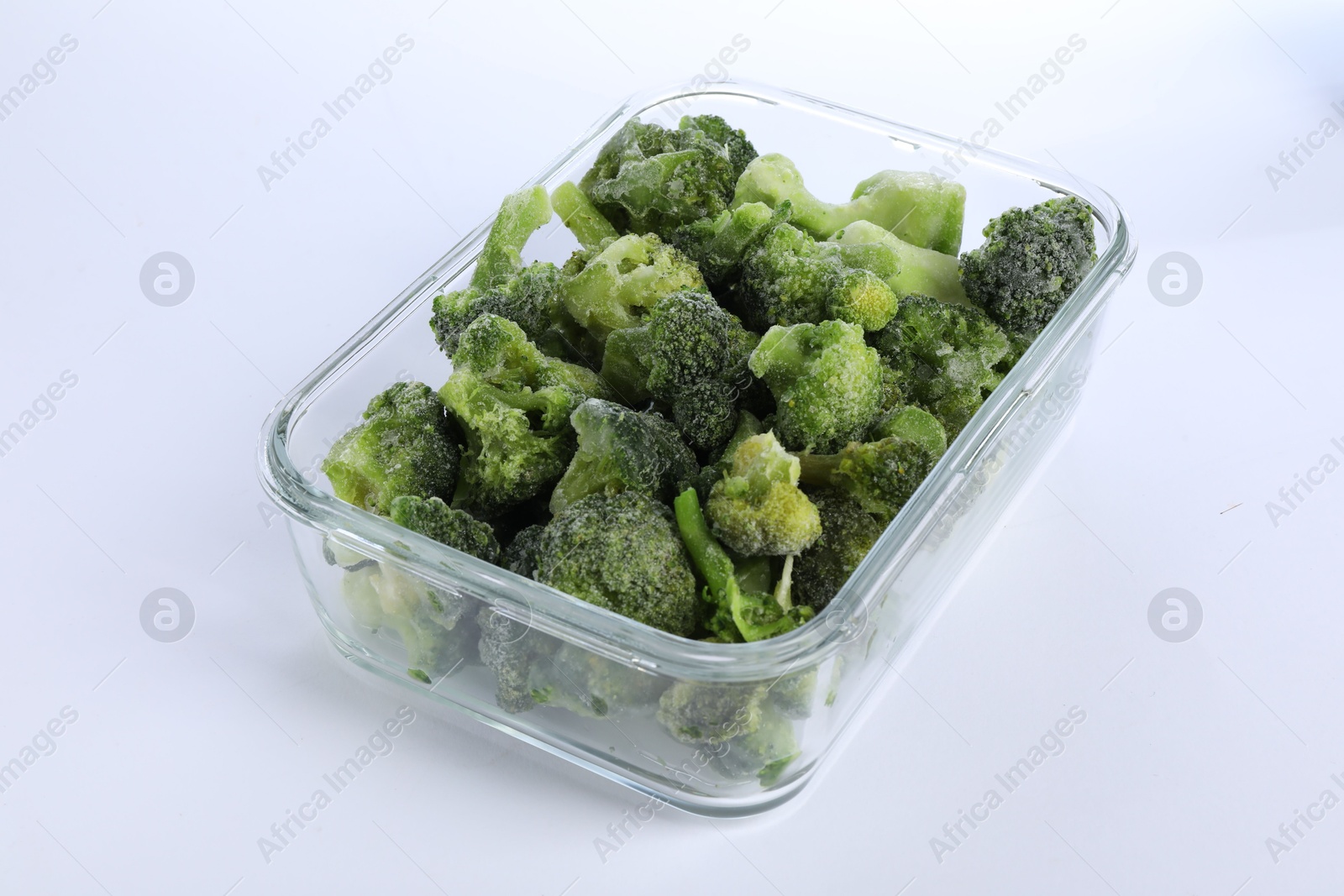 Photo of Frozen broccoli in container isolated on white