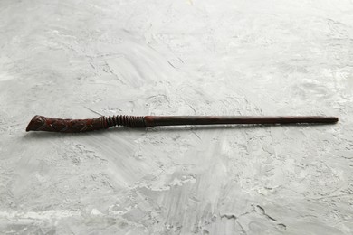 Photo of One old magic wand on grey textured table