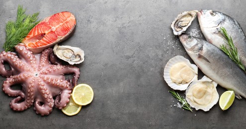 Different sea food on grey table, flat lay. Space for text