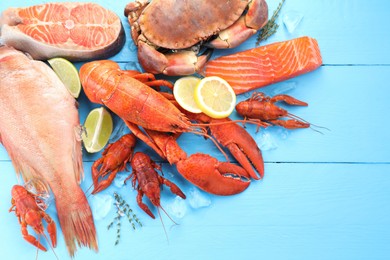 Photo of Different sea food on light blue wooden table, flat lay