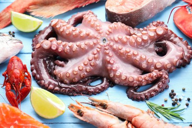 Different sea food on light blue wooden table, closeup