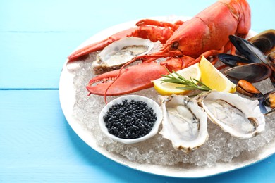 Photo of Many different sea food on light blue wooden table, closeup