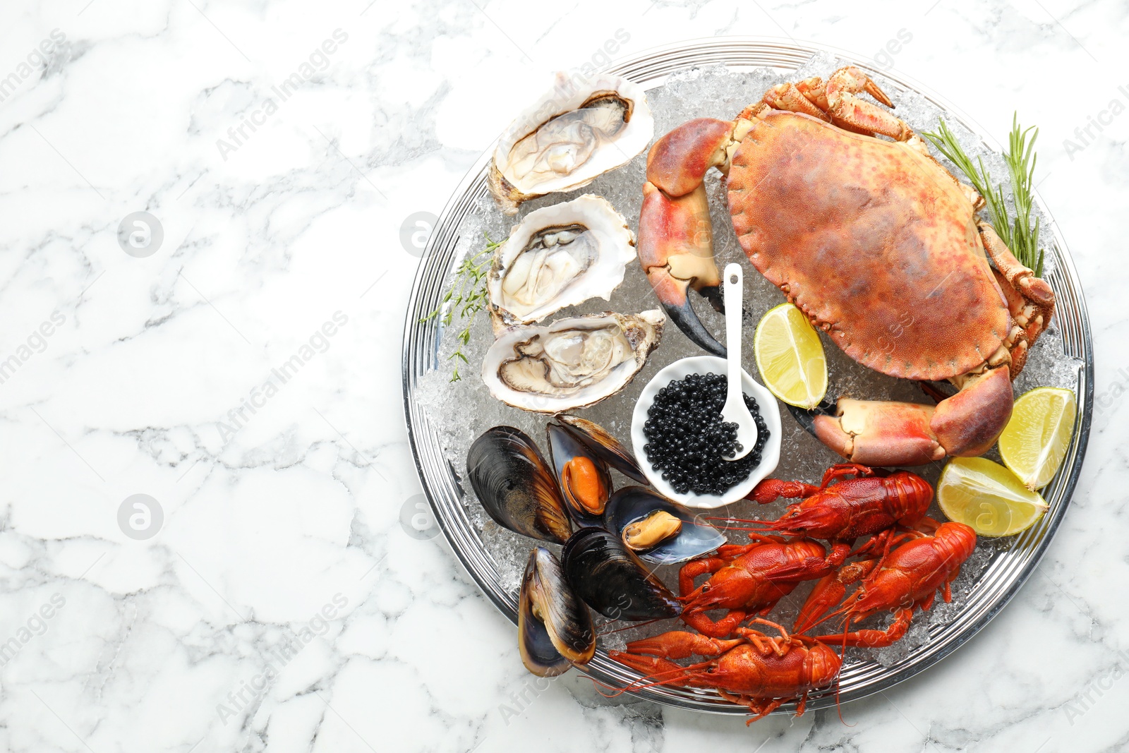 Photo of Many different sea food on white marble table, top view. Space for text