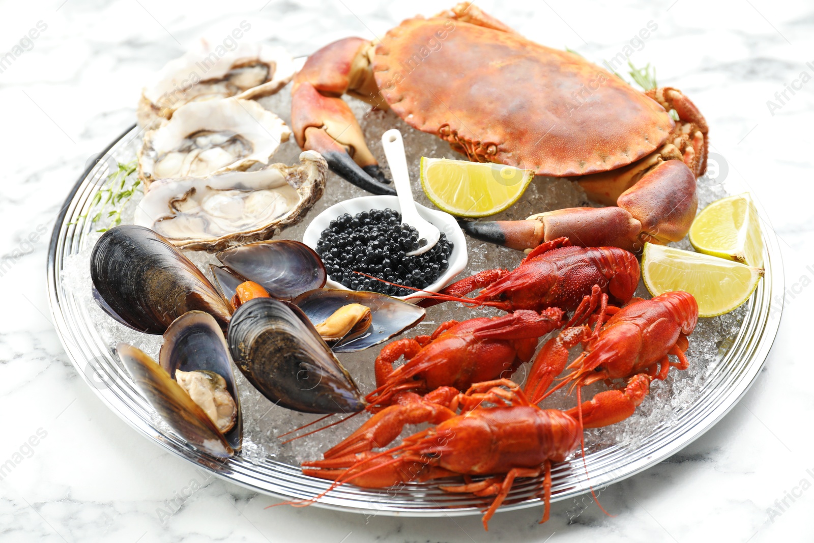 Photo of Many different sea food on white marble table, closeup