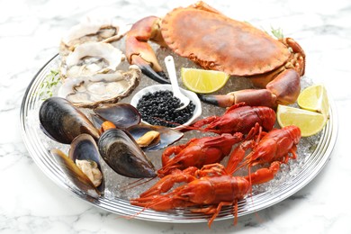 Photo of Many different sea food on white marble table, closeup