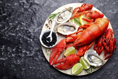 Photo of Many different sea food on dark table, top view