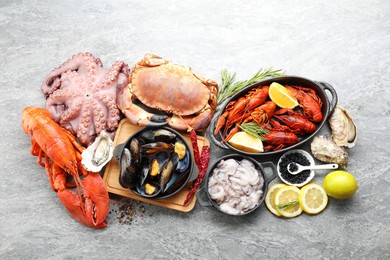 Photo of Many different sea food on grey table, top view