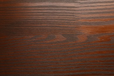 Photo of Texture of wooden surface after applying walnut wood stain as background, top view