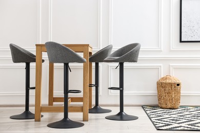 Photo of Bar stools near table in stylish room