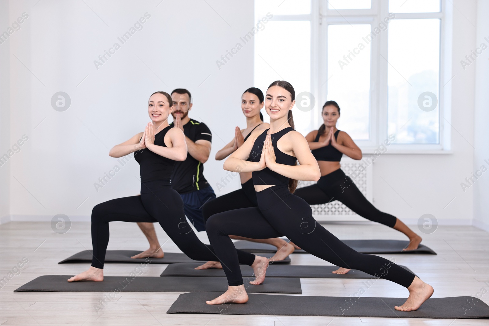 Photo of Group of people practicing yoga on mats in class