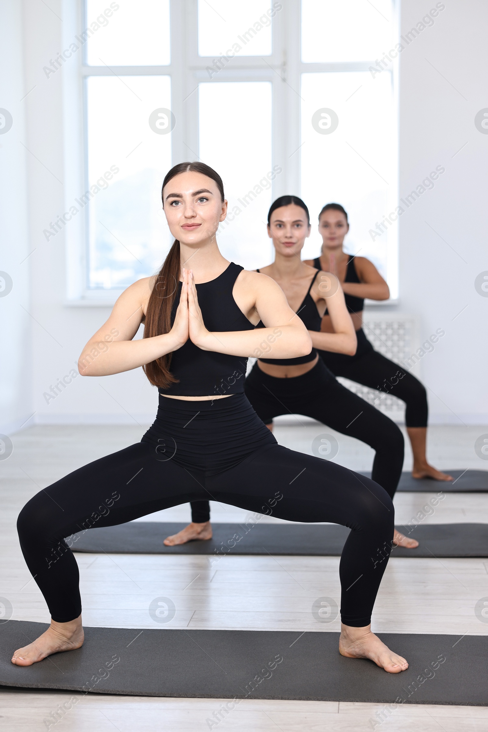 Photo of Group of people practicing yoga on mats in class