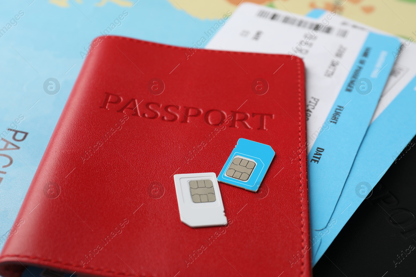 Photo of Passport, SIM cards and tickets on table, closeup