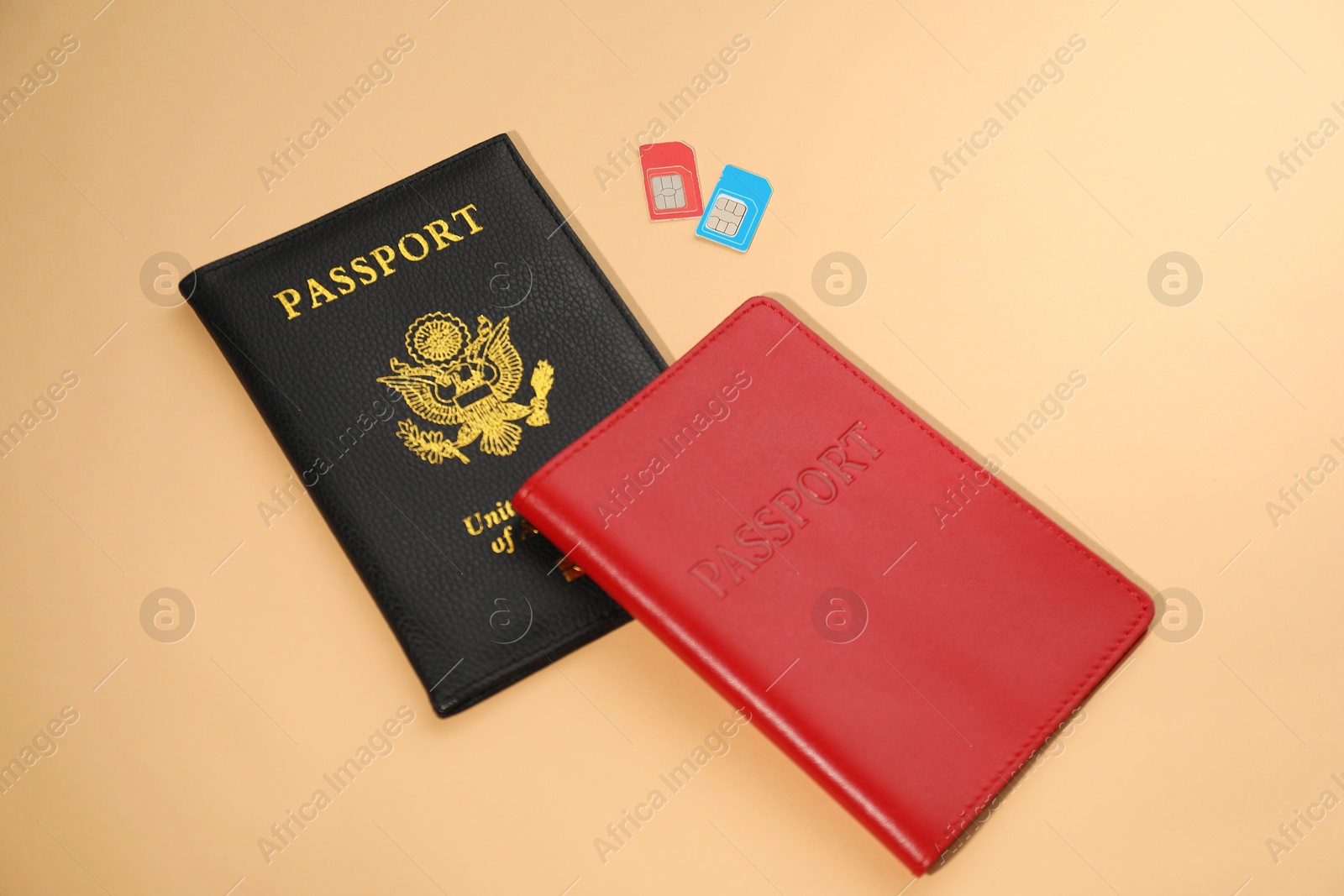 Photo of Modern SIM cards and passport on beige background