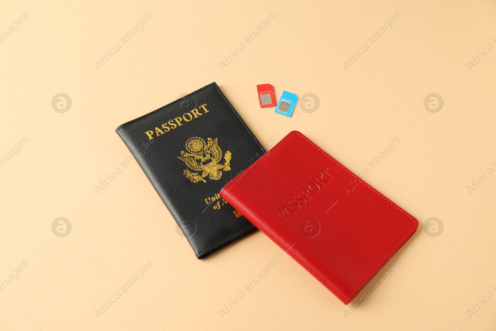 Photo of Modern SIM cards and passport on beige background