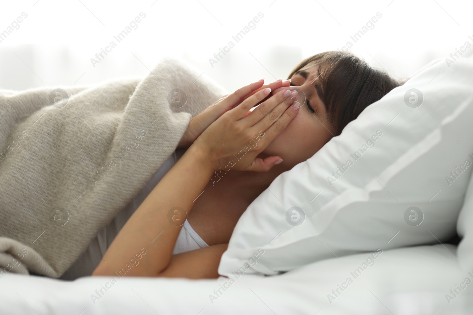 Photo of Woman suffering from sinusitis in bed indoors