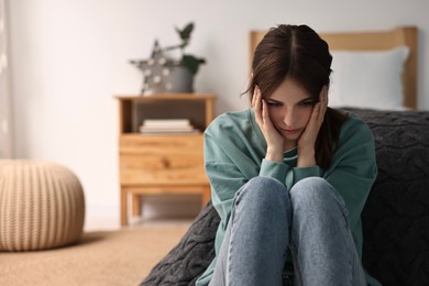 Photo of Loneliness concept. Sad teenage girl at home, space for text