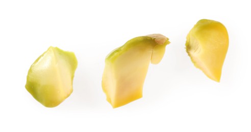 Photo of Pieces of peeled pistachio nut isolated on white