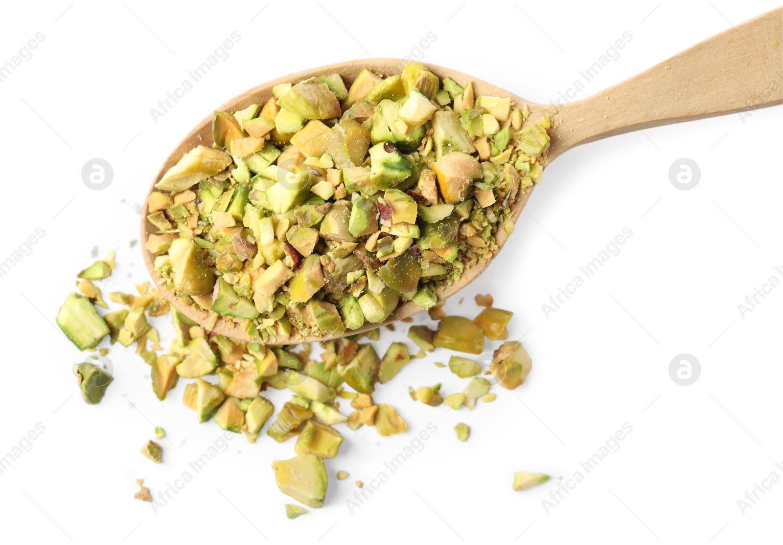 Photo of Pieces of peeled pistachio nut in wooden spoon isolated on white