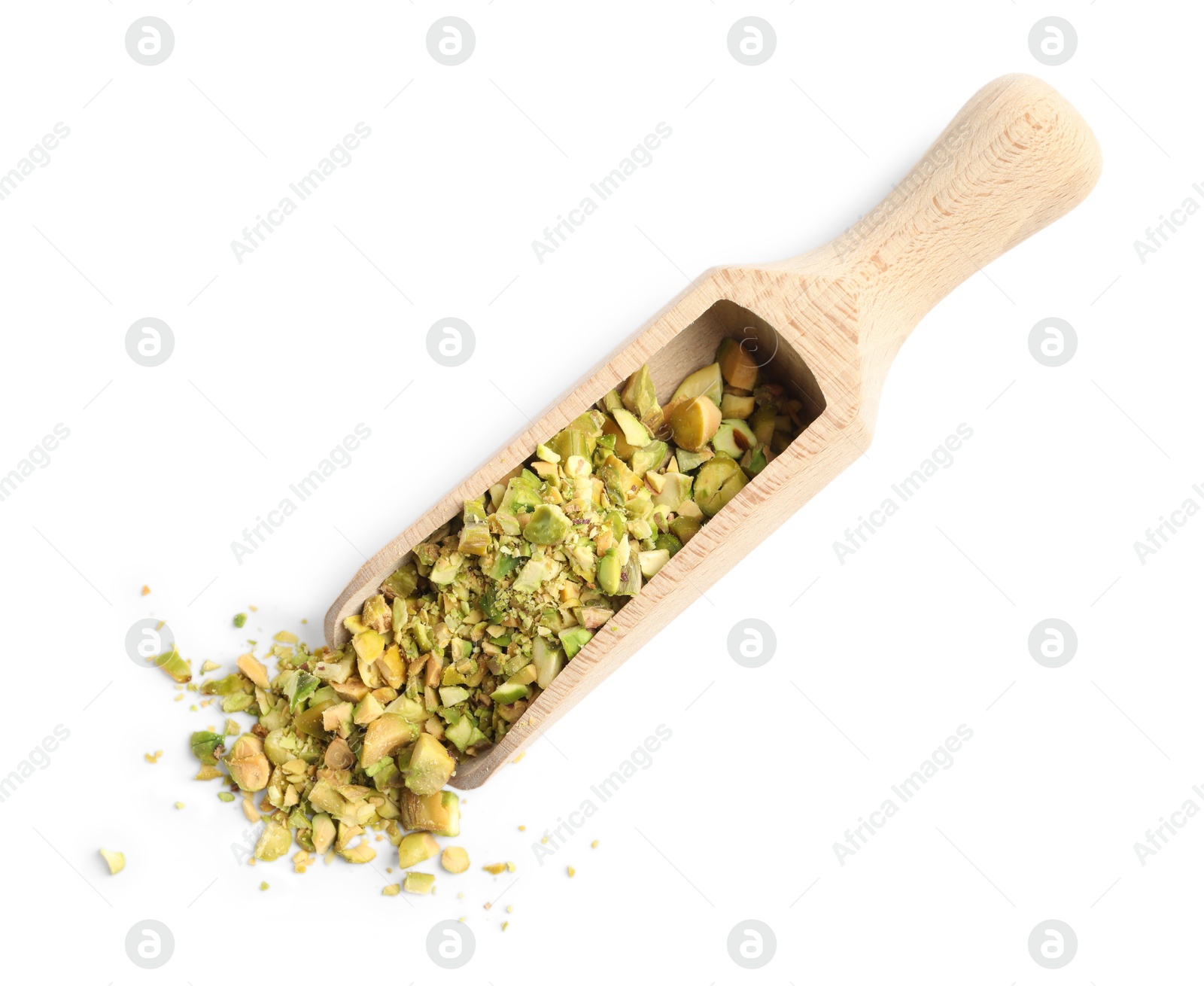 Photo of Pieces of peeled pistachio nut in wooden scoop isolated on white, top view