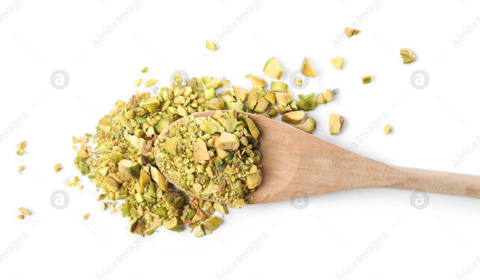 Photo of Pieces of peeled pistachio nut in wooden spoon isolated on white, top view