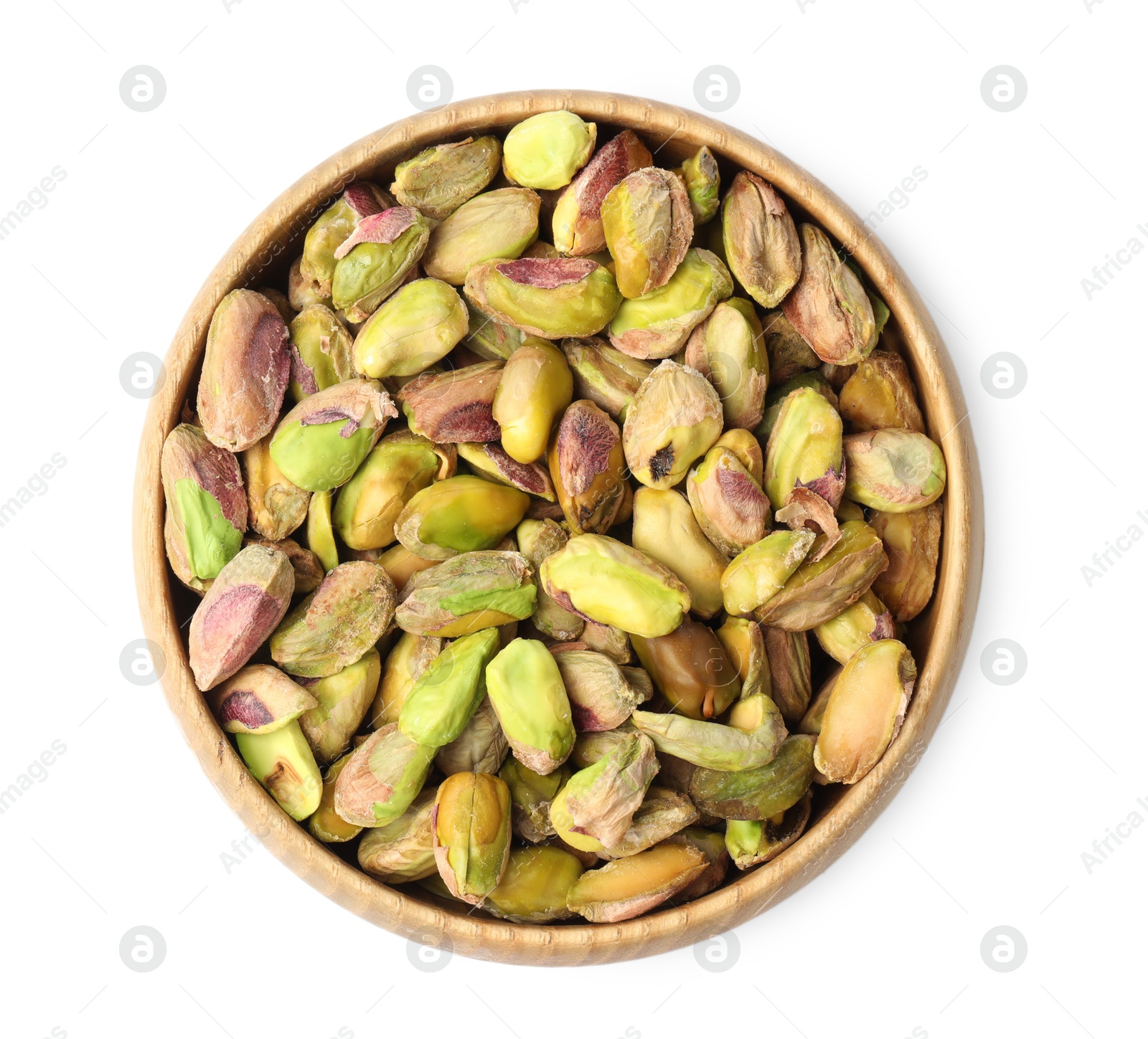 Photo of Peeled pistachio nuts in bowl isolated on white, top view