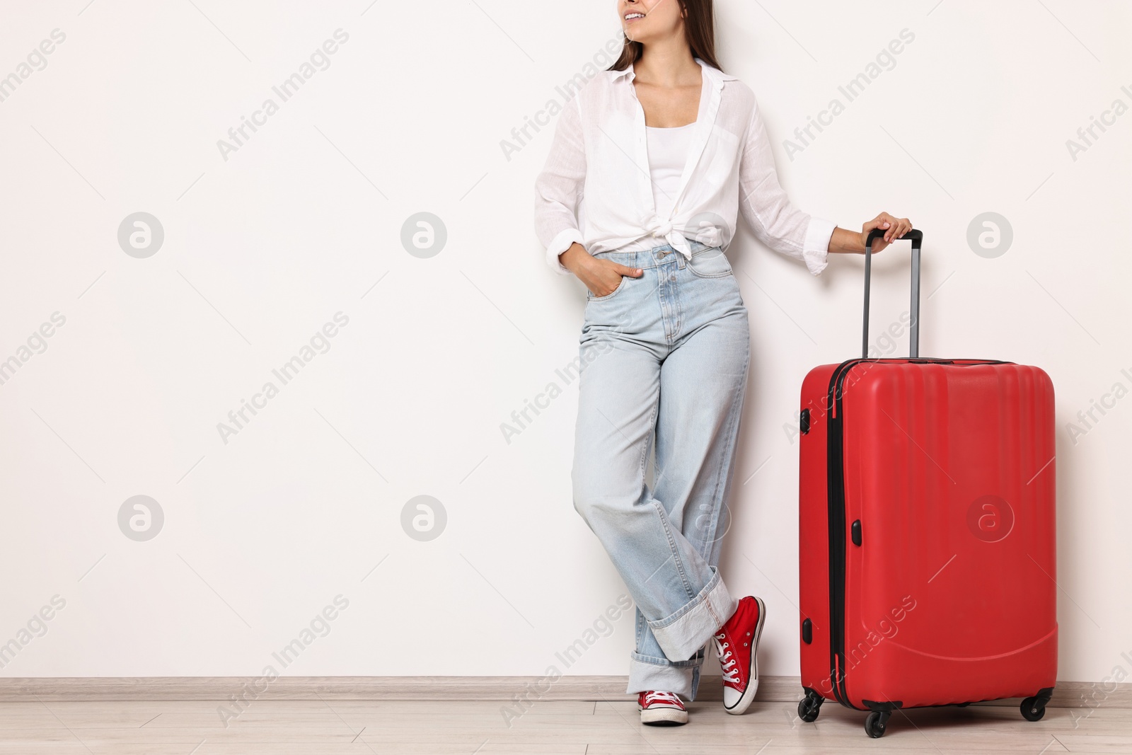 Photo of Woman with suitcase indoors, closeup. Space for text