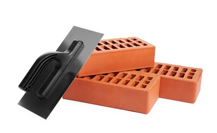 Photo of Red bricks and plastering trowel on white background