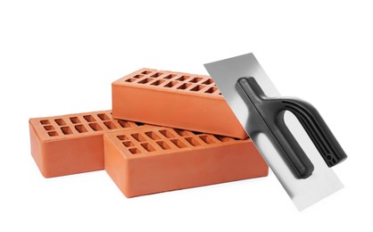 Photo of Red bricks and plastering trowel on white background