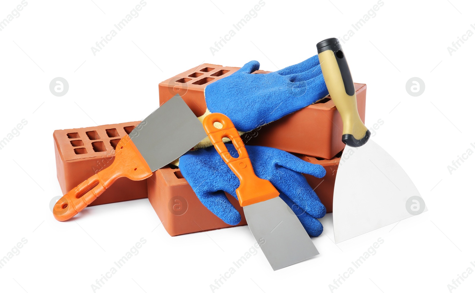 Photo of Red bricks, gloves and trowels on white background