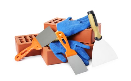 Photo of Red bricks, gloves and trowels on white background