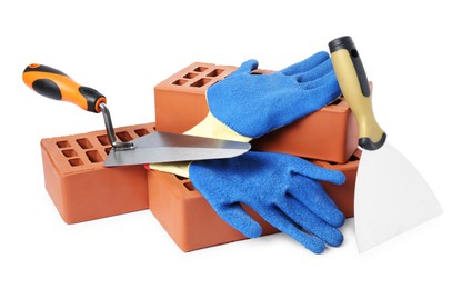 Red bricks, gloves and trowels on white background