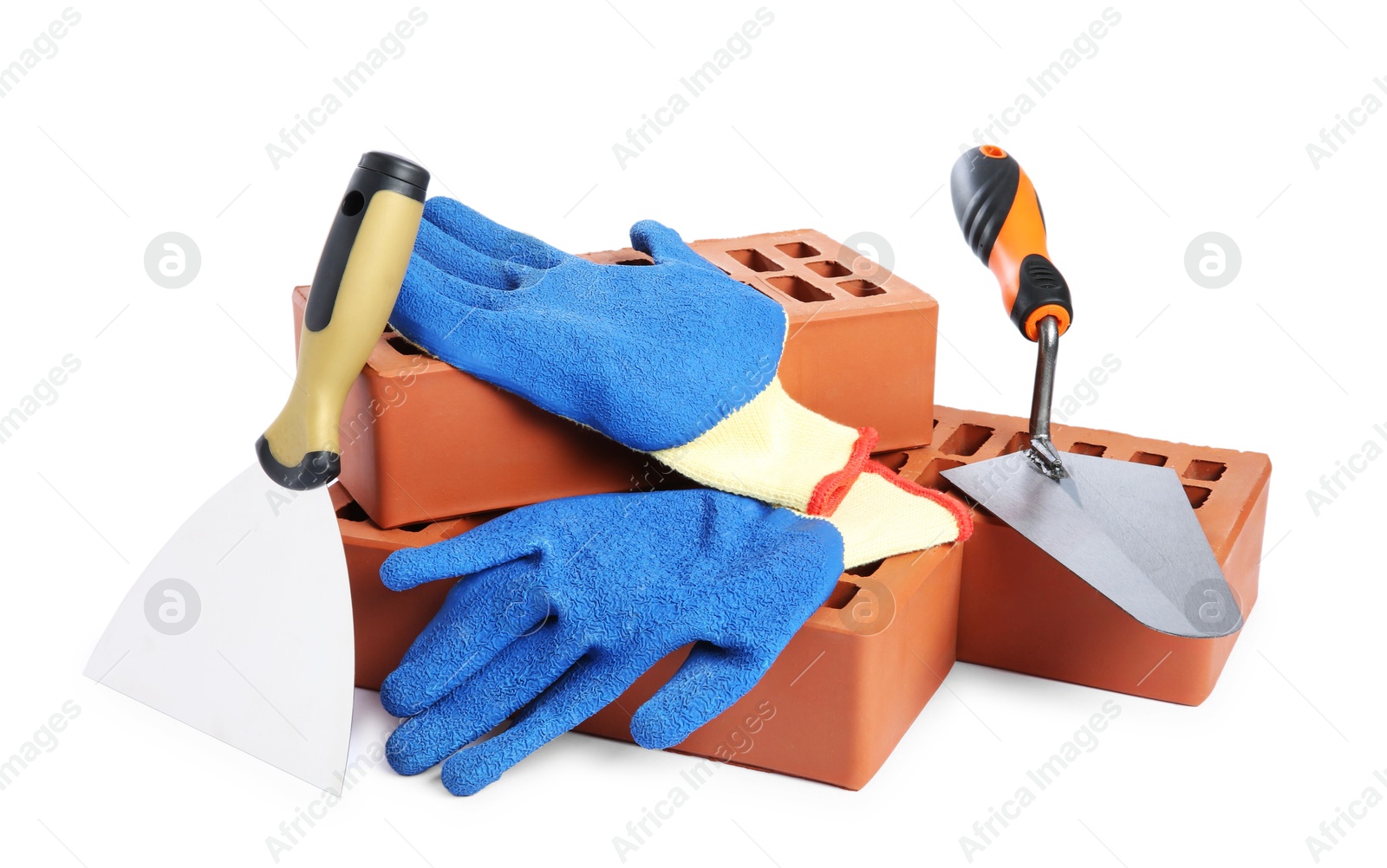 Photo of Red bricks, gloves and trowels on white background