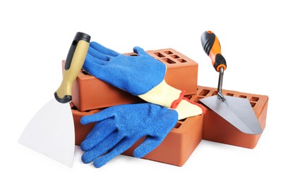 Red bricks, gloves and trowels on white background