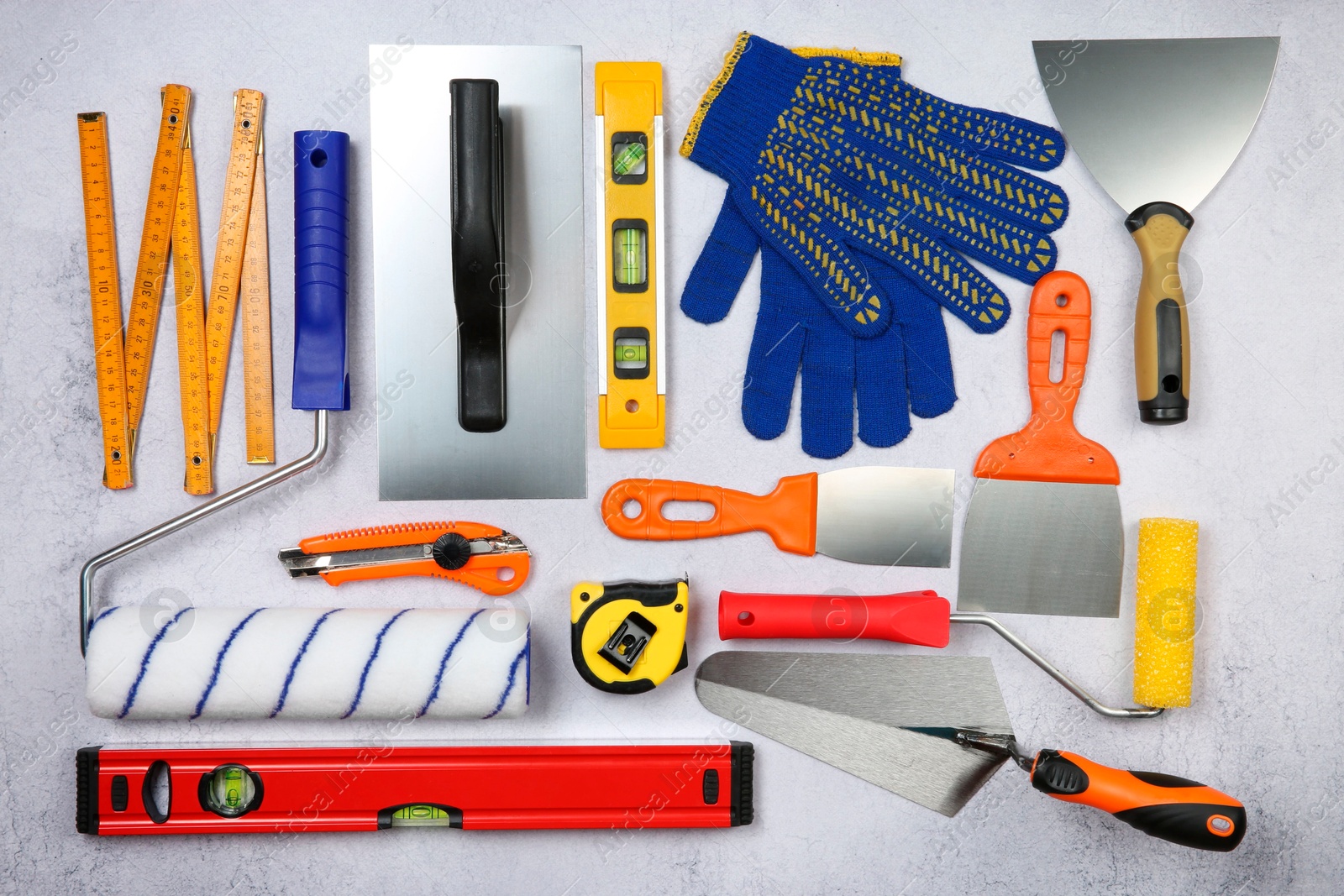 Photo of Flat lay composition with different construction tools on grey textured table