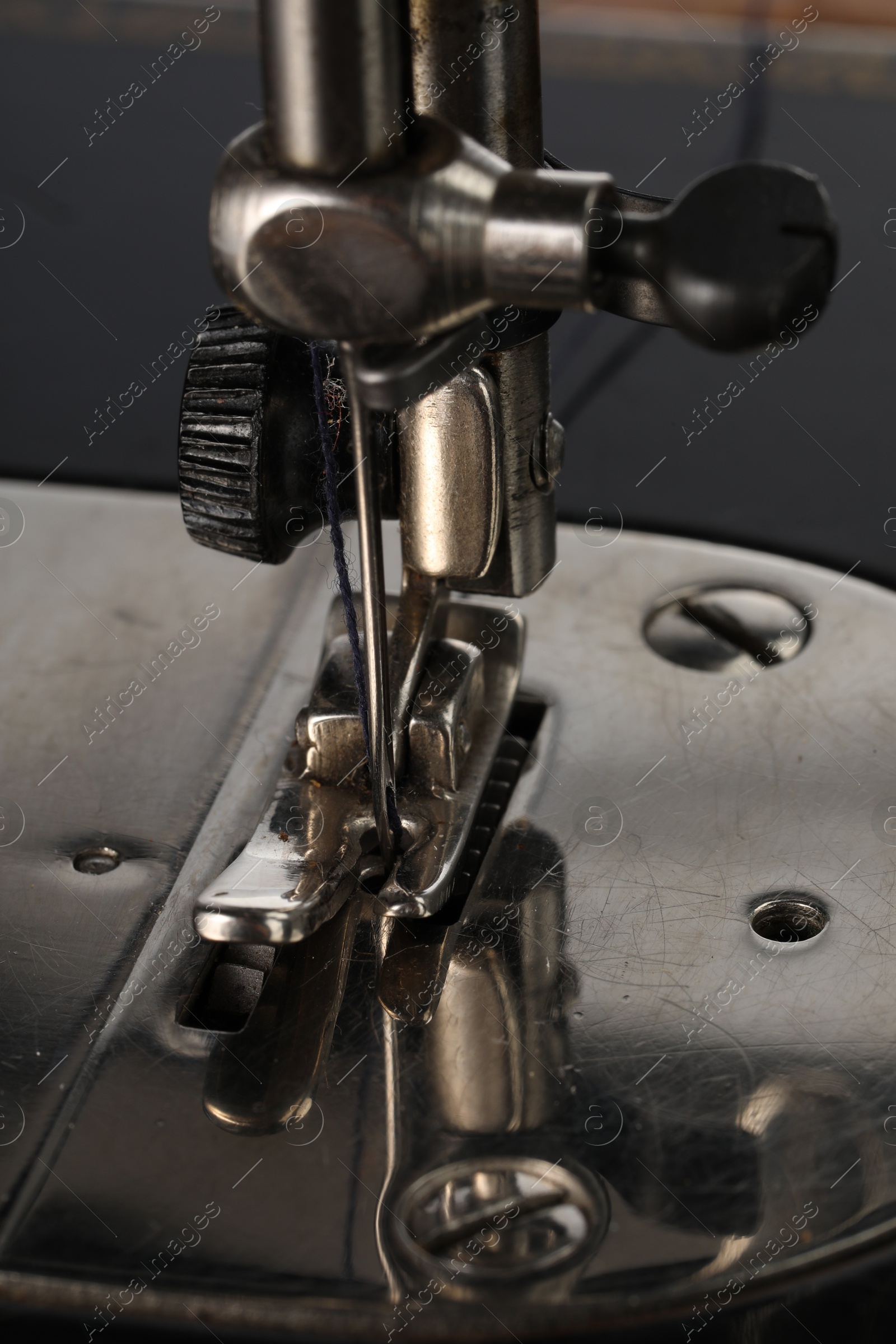 Photo of Sewing machine on grey background, closeup view