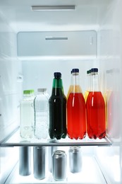 Photo of Many different cold drinks in refrigerator, closeup