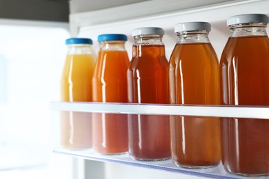 Many bottles of juice in refrigerator, closeup