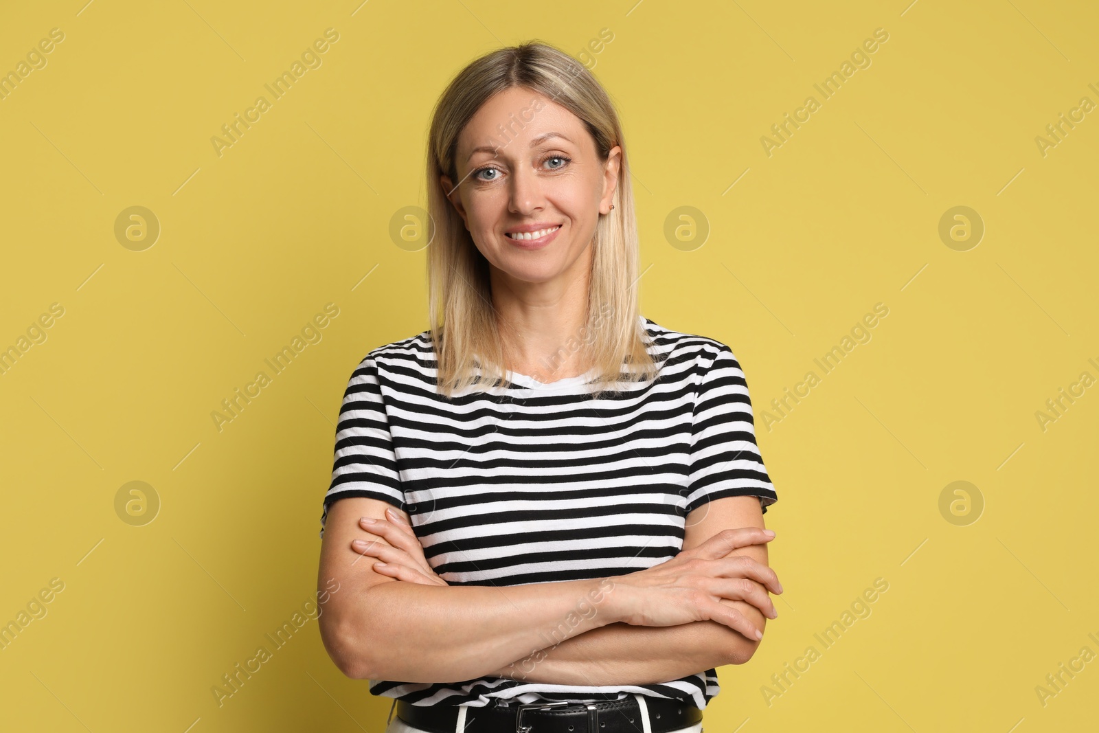 Photo of Portrait of beautiful smiling woman on yellow background