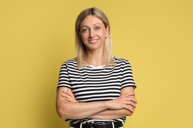 Photo of Portrait of beautiful smiling woman on yellow background