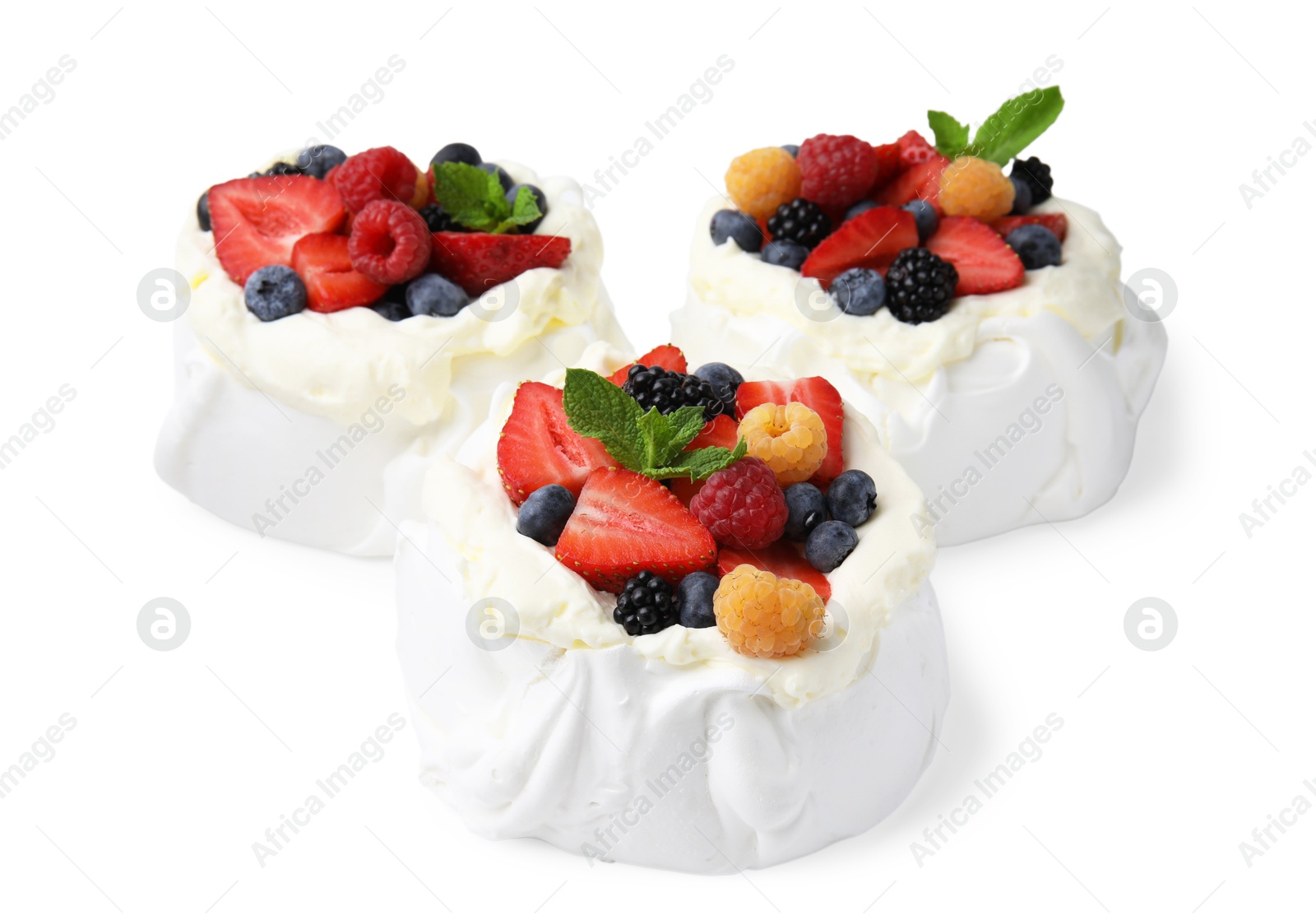 Photo of Pavlova cake (meringue dessert) with whipped cream, fresh berries and mint isolated on white